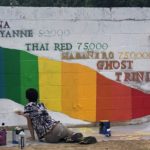 Volunteers painting mural